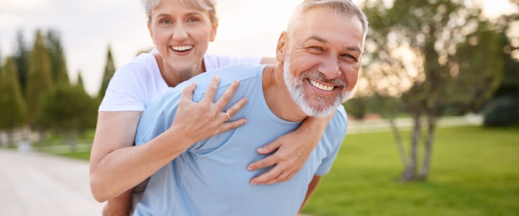 man giving his wife a piggy back